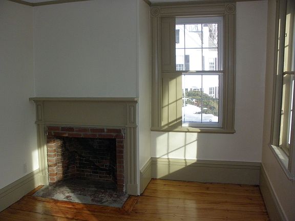 Bedroom - showing interior shutters and non-functional fireplace,