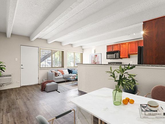 Bright living space with exposed beams and natural light.