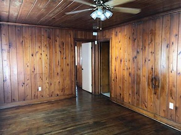 LIVING ROOM_NATURAL WOOD WALLS & FLOORS_3 BRIGHT FRONT & SIDE WINDOWS