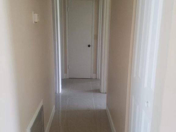 Hallway ending at laundry closet