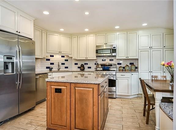 Beautiful redesigned Eat-in-Kitchen with granite counters, stainless steel appliances, built in benches.  Tons of Storage
