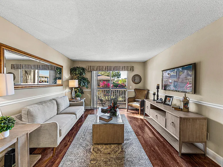 Comfortable living room featuring wood-style flooring and access to a private balcony.