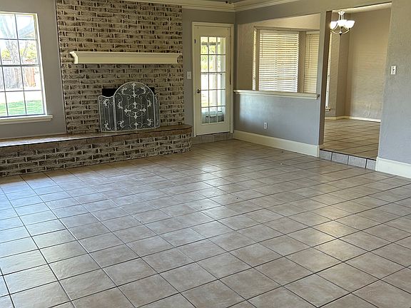Family room with gas log fireplace steps up to the kitchen and eat in dining nook