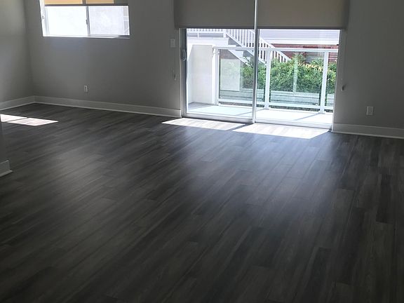 Living Area With Sliders Going to a East Facing Balcony