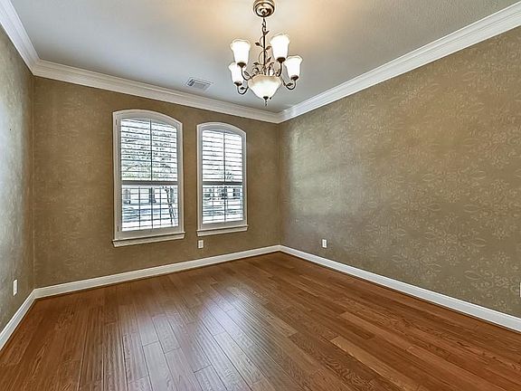 I Love the Decorator Stenciled Walls in This Dining Room that also Features Wood Floors!