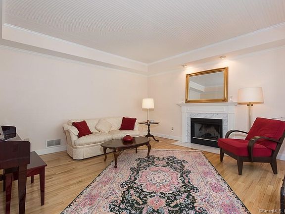 Formal living room with tray ceiling and fireplace