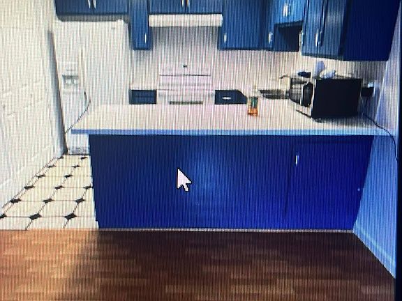 Kitchen with Fridge and Microwave included. Also included behind pantry doors are a washer and dryer.