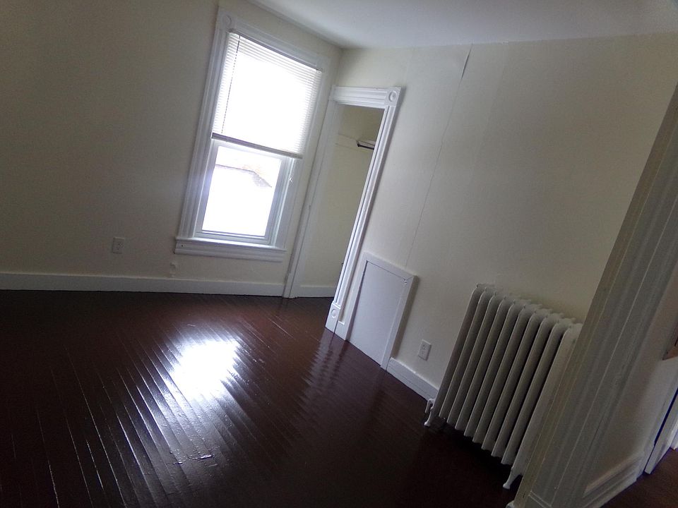 living room with closet. beautiful painted wood floors
