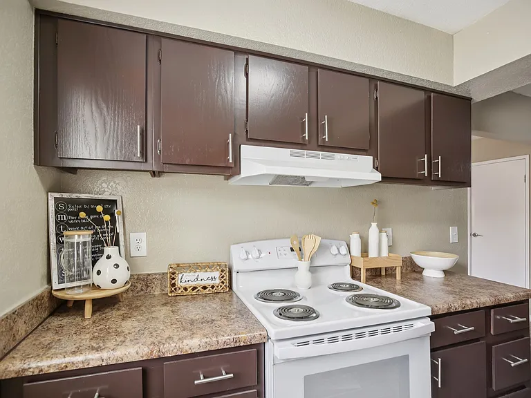 One bedroom kitchen with multiple cabinets and drawers.