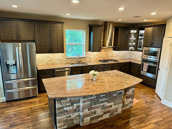 A chef's kitchen. All stainless steel appliances and large custom granite island!