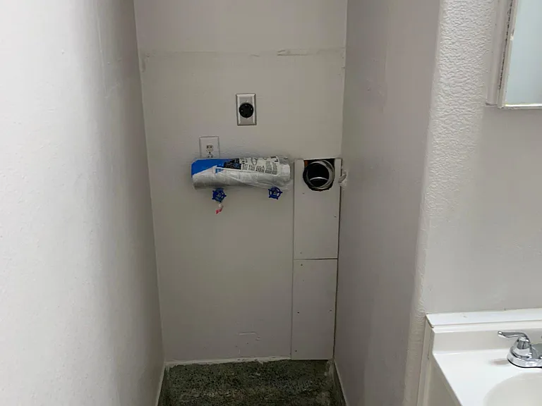 Stackable washer/dryer connections in bathroom