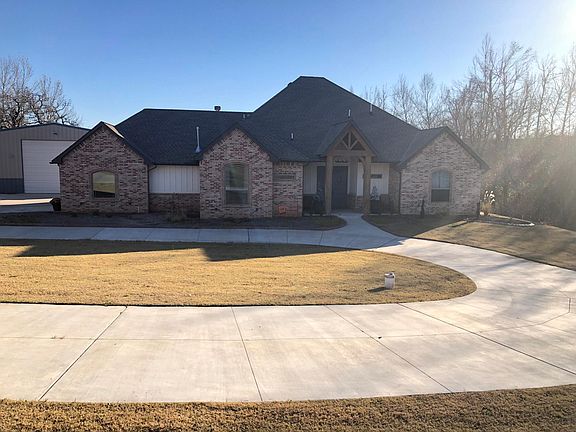 Front with circle drive and double door entrance.