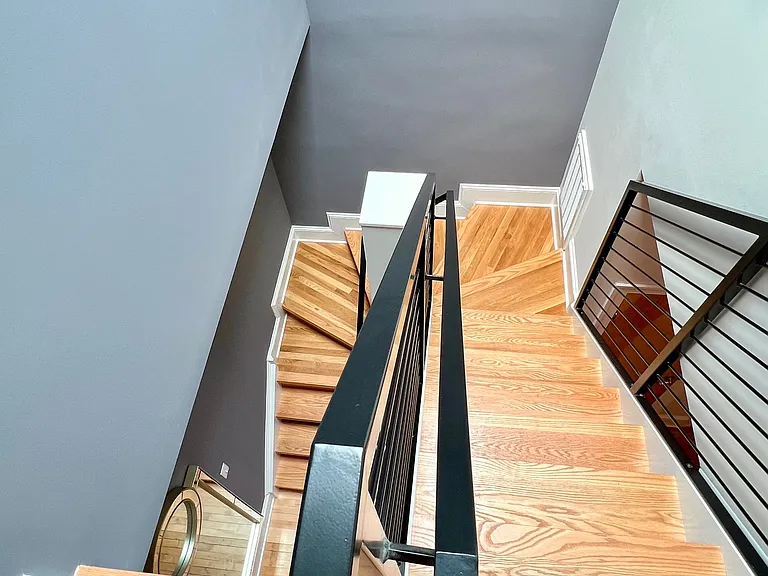 Custom staircase from top, front entry level to living/dining/kitchen level.