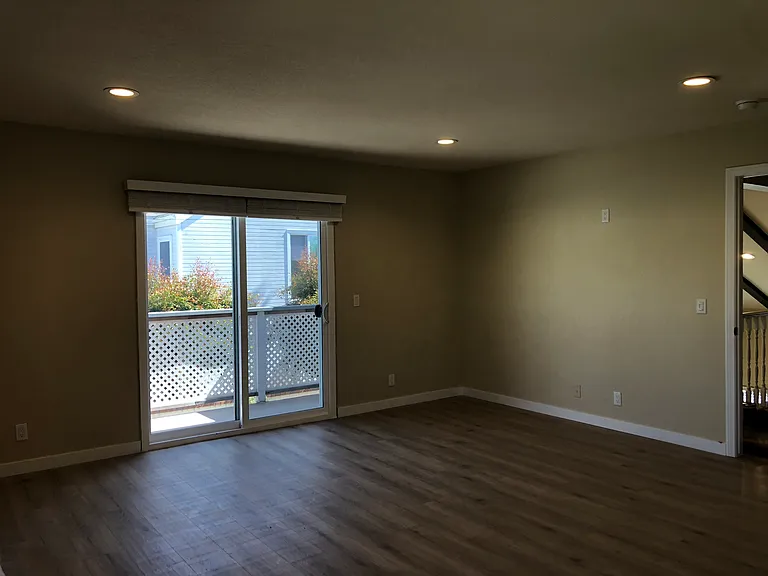 Primary bedroom with sliding door onto balcony