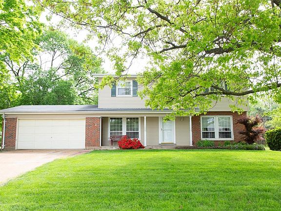 This brick & vinyl home offers 1980 sq ft of comfortable living space.