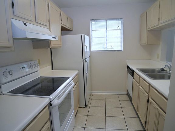Kitchen with smooth top stove, dishwasher, refrigerator with