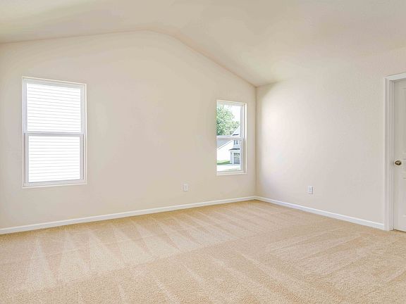 Master bedroom features high ceilings, natural light, private bath and walk-in closet