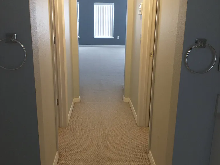 Hallway with 2 walk in closets located in 2nd floor master bedroom suite.