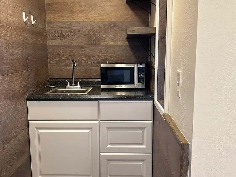Kitchenette sits by full size range and oven