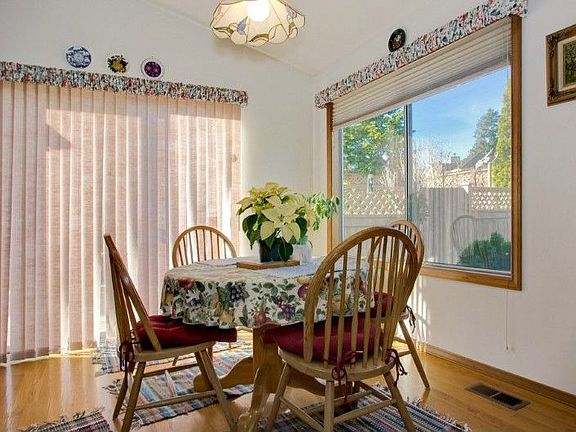 Dining area off kitchen. Sliders lead to deck and backyard. Over-sized windows throughout home!
