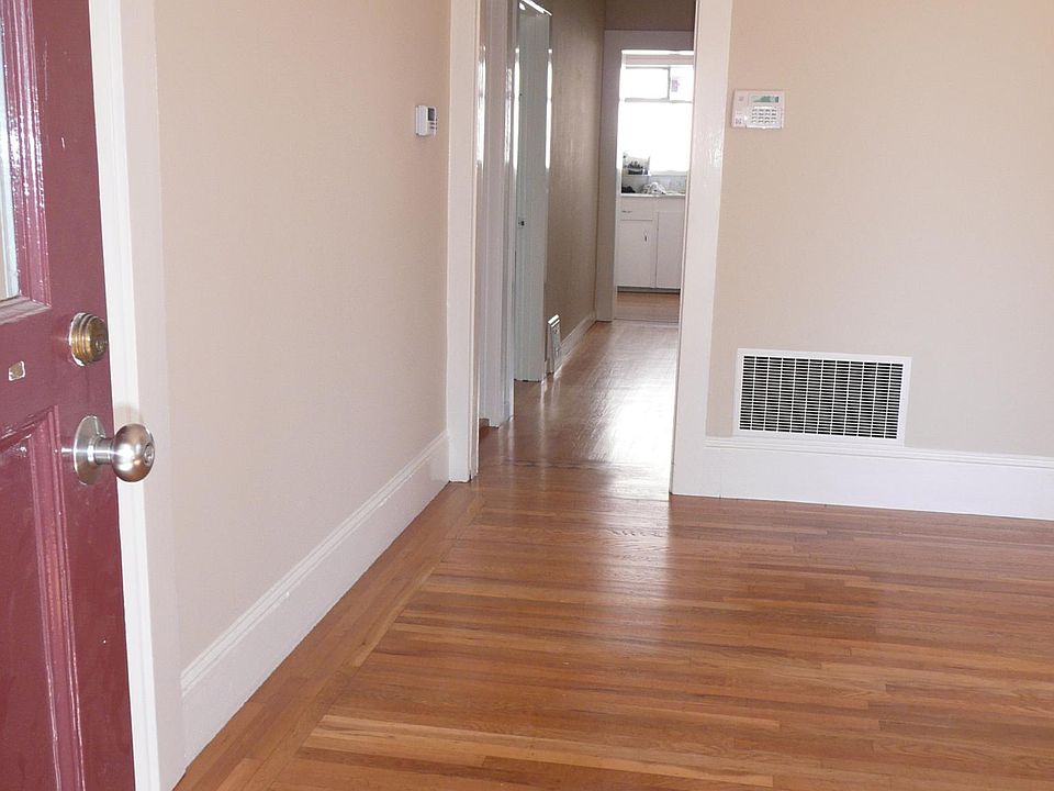 View entering flat, hardwood floors and hall to kitchen