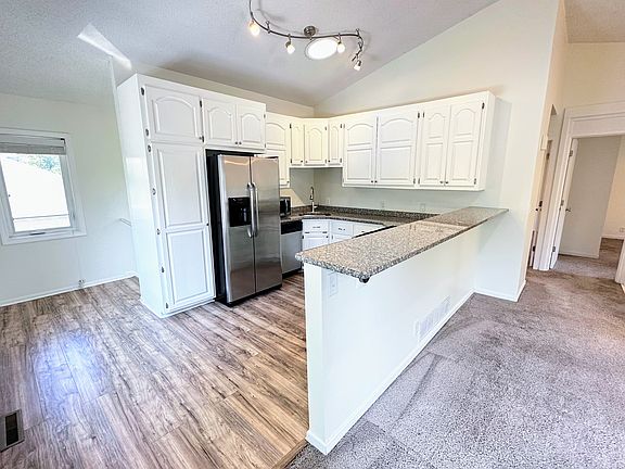 Upgraded kitchen with stainless appliances, gas stove, granite countertops