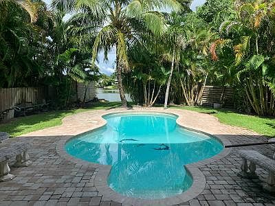 Pool view over looking lake in private fenced back yard