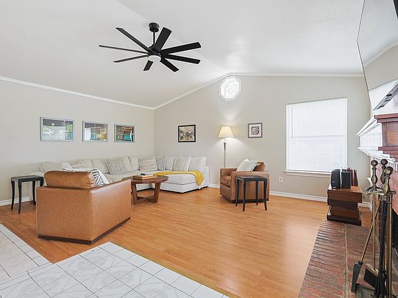 Unwind in a spacious, open-concept living room featuring plenty of comfortable seating meaning there is room for everyone to relax and make lasting memories together.