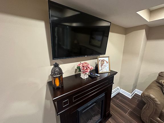 TV and electric fireplace located in the living room/kitchen.