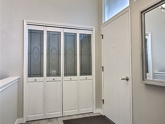 Vaulted ceiling foyer and open space upon entry