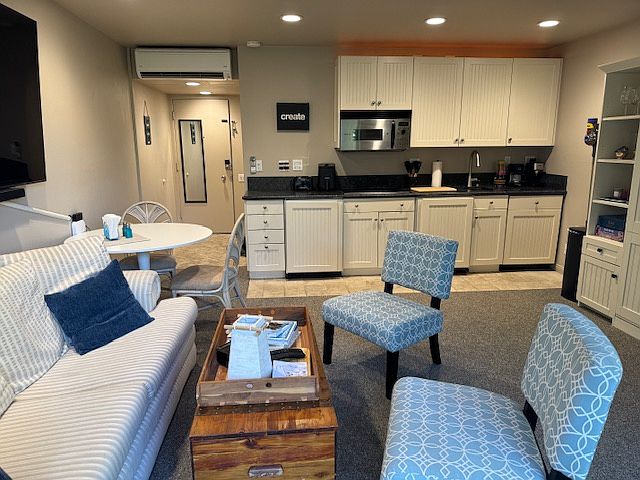 Seating area with kitchen in rear.