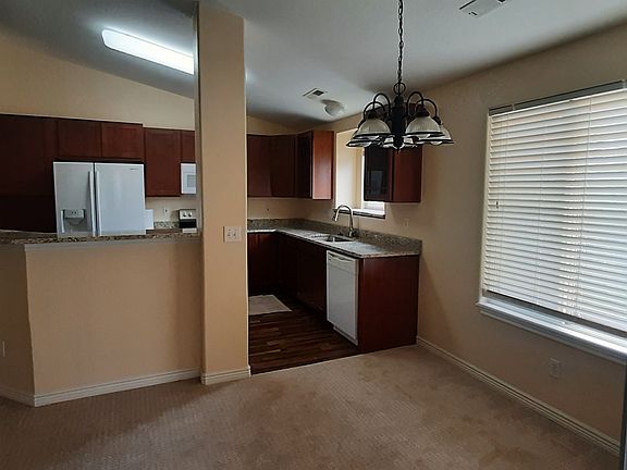 With a tranquil view from the kitchen sink, the kitchen included a roomy side by side fridge with water and ice in the door, a built-in microwave, range and dishwasher. Eat in dining space adjacent to the kitchen.