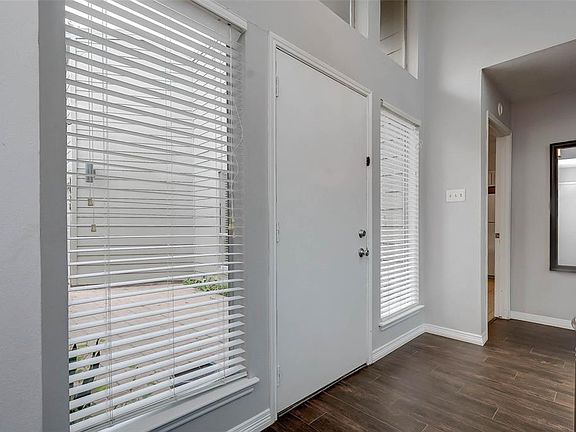 At the front entry you are greeted with newly installed tile-wood floors.
