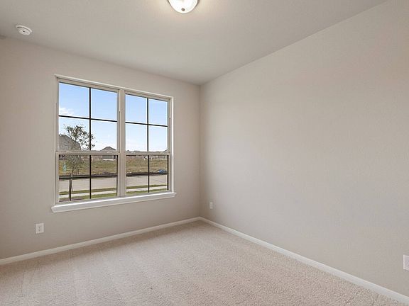 Your secondary bedroom features plush carpet, fresh paint, closet, and a large window that lets in p