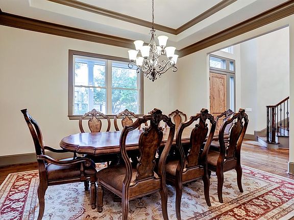 A well proportioned dinging room boasting details such as the tray ceiling with crown molding, hardwoods with details at entry points, great wall space for china cabinets/sideboards/art! the dining room overlooks the front porch and yard. it also has