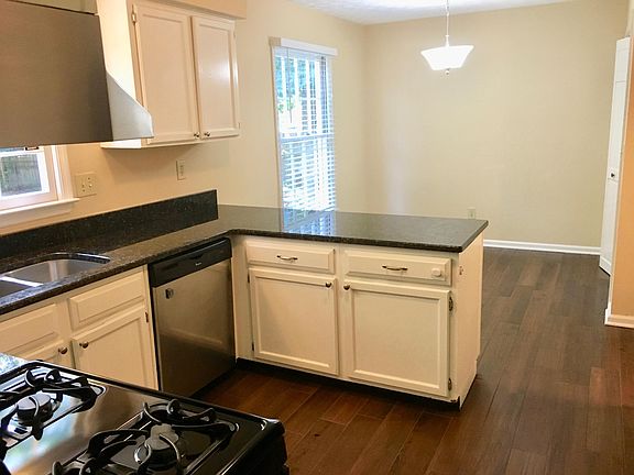 Bright, open breakfast room with counter island.