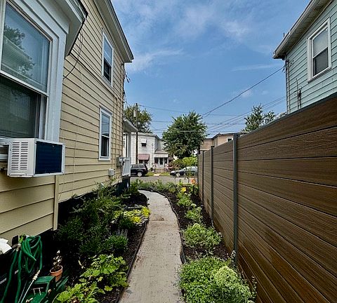 A brightly lit, lush garden path guides you to your new home.