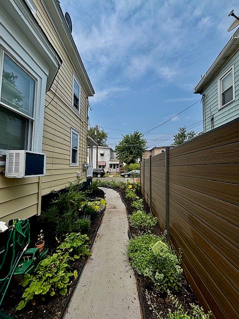 A brightly lit, lush garden path guides you to your new home.