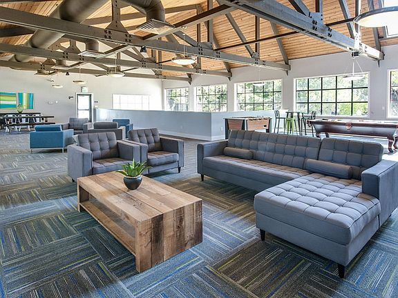 Resident Lounge with large windows and exposed beams.