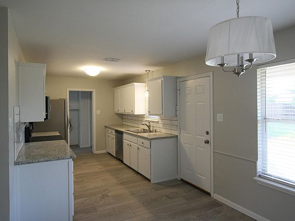Kitchen with granite counter tops and new back splash. New dishwasher, range and refrigerator.