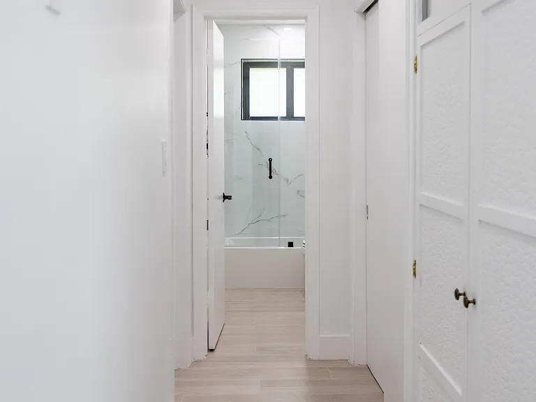 Hallway with linin closets between master bedroom and 2nd bathroom