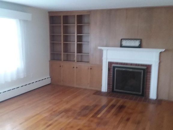 Living room with built in book shelves.