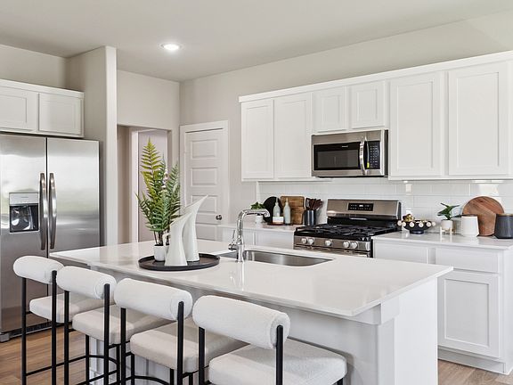 Kitchen in the Magnolia home plan by Trophy Signature Homes - REPRESENTATIVE PHOTO