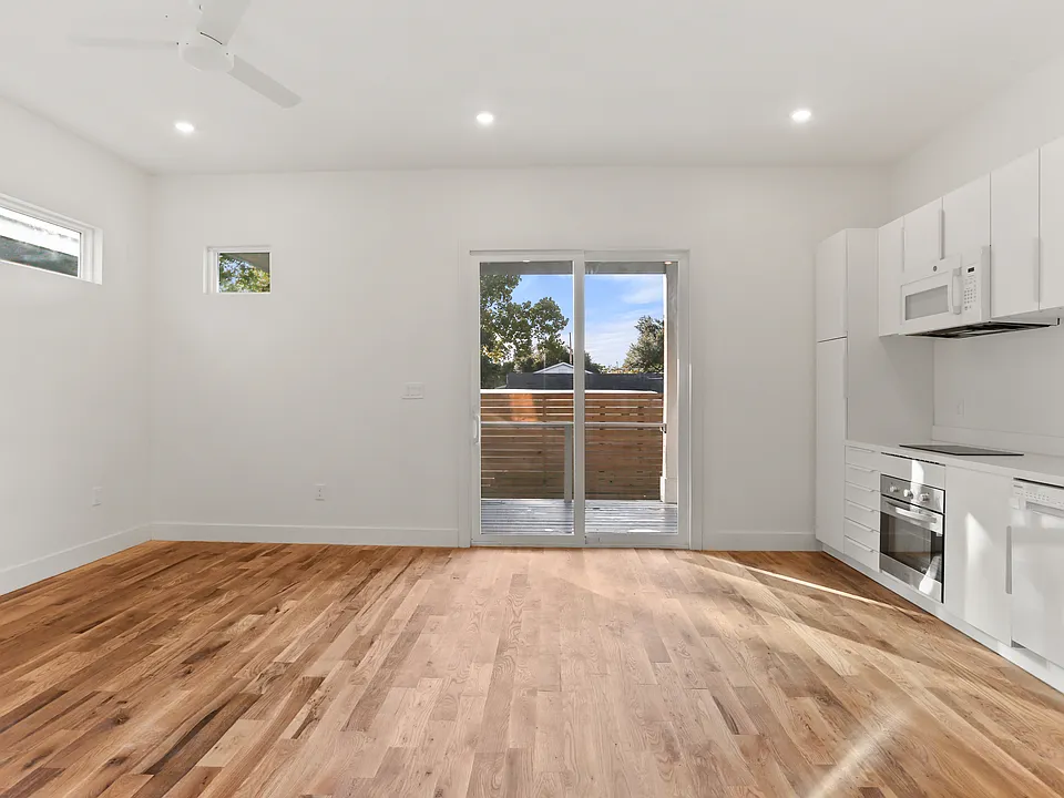 Main living room features a large slider onto the semi-private back porch.