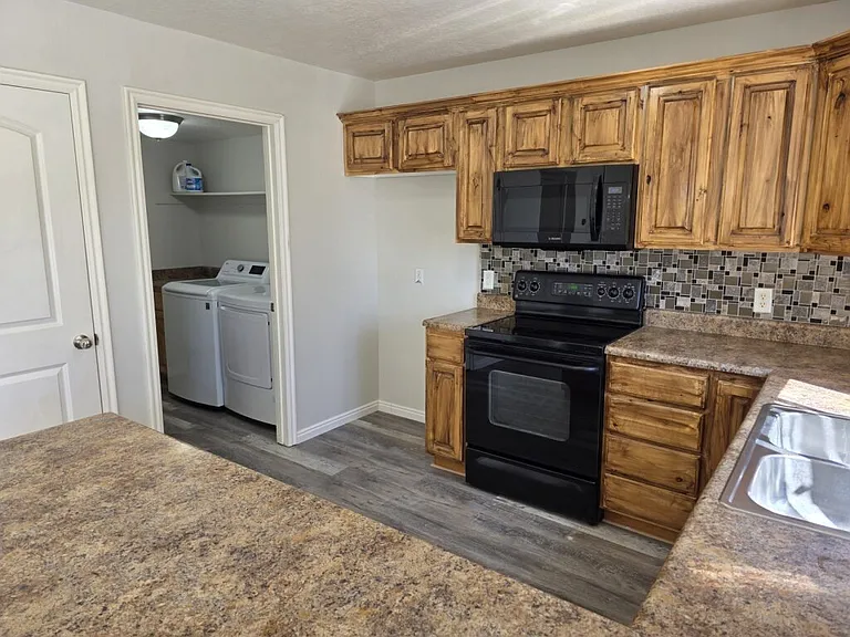 Stainless steel refrigerator coming soon. Electric Stove and pantry lots of cabinet space and laundry room with shelves