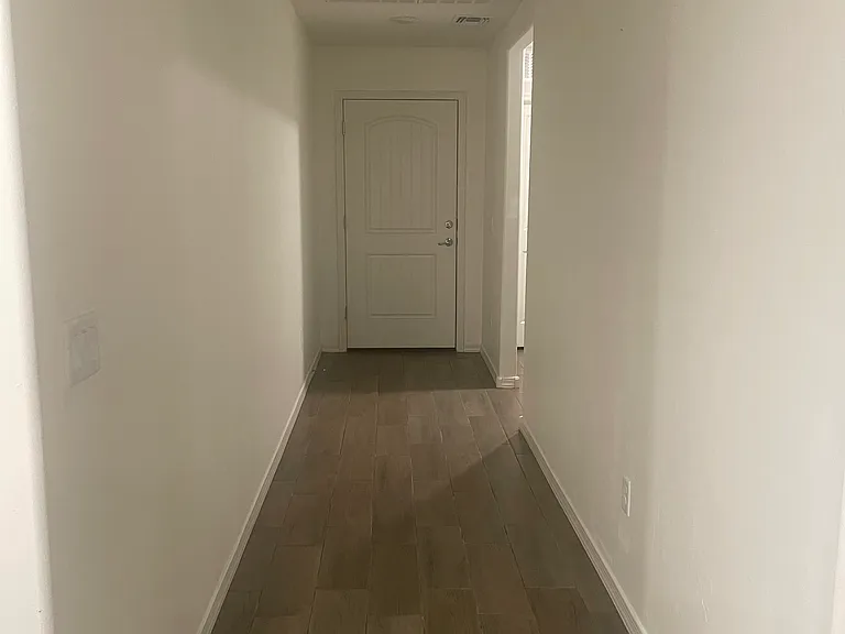 Entrance way, hallway in front leads to two guest bedrooms and bathroom