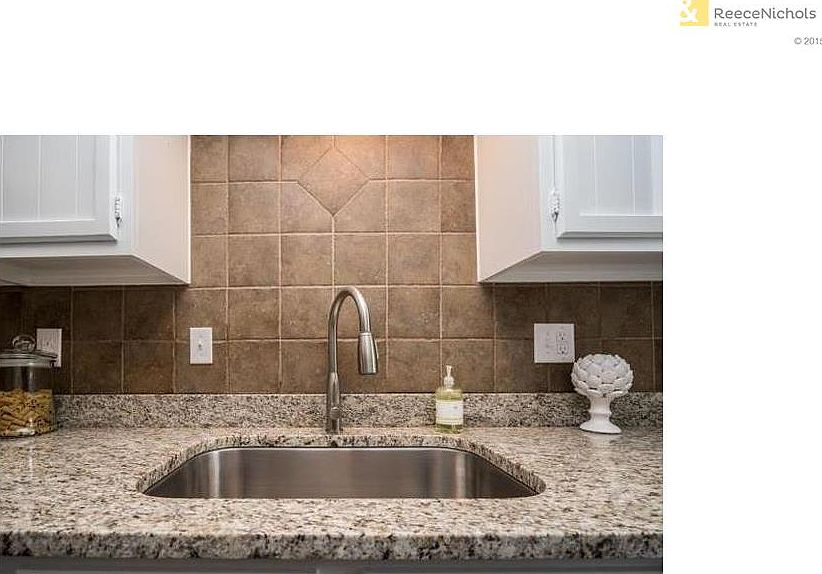 Kitchen features granite surfaces