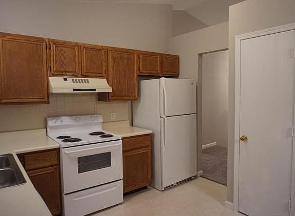 All kitchen appliances will stay, including the refrigerator. Pantry is on the right. Note the plant shelf below the vaulted ceiling.