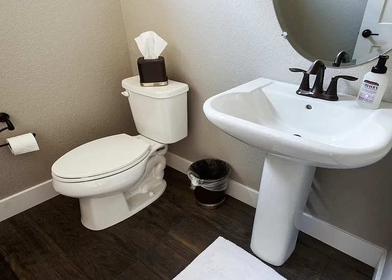 Stairway to 2nd floor leads to Kitchen and Living Room, with this half bathroom on the same floor.