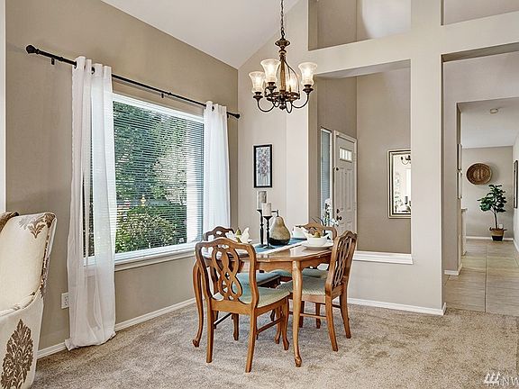 Another view of Formal Dining Room with Large Picture Windows and Soaring Vaulted Ceilings